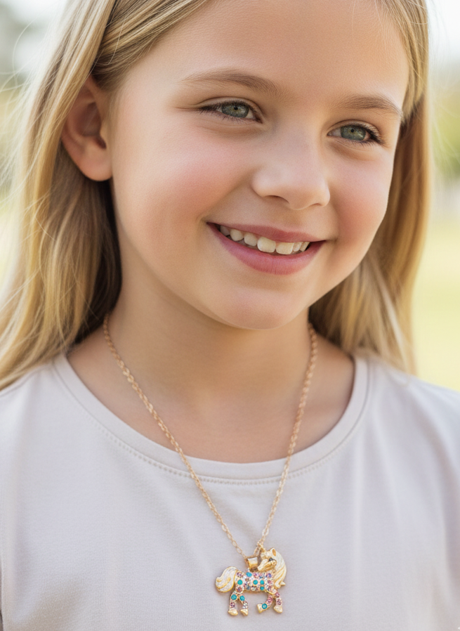 Young girl wearing a necklace with a colorful pendant outdoors
